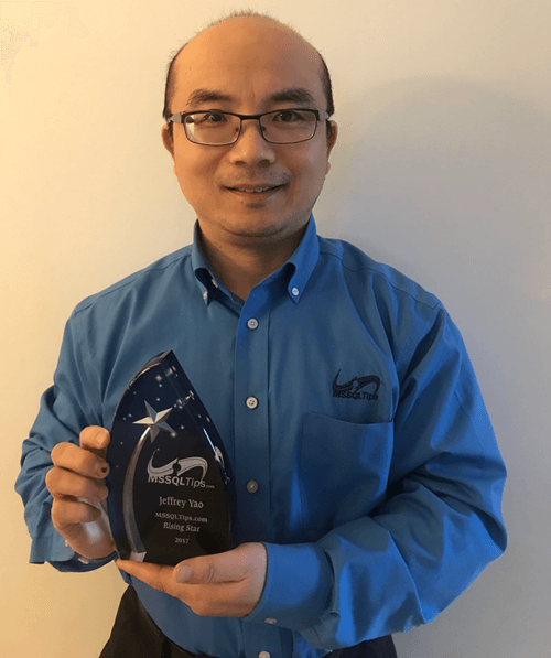 Jeffrey Yao proudly holding his 2017 MSSQLTips.com